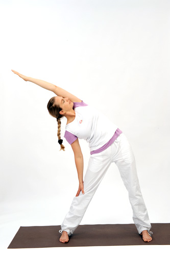 <b>TRIANGLE (TRIKONASANA)</b> – The Triangle increases peristalsis of the digestive tract. This encourages better working of the bowels and assists digestion. The liver is massaged and secretes more abundantly. It promotes hip and leg flexibility.